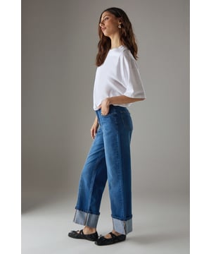Wide leg design with distinctive front seam detailing for a contemporary silhouette
        Generous turn-up cuffs adding structural interest and versatility to the styling
        Cotton denim fabric offering comfort and durability for everyday wear
        Classic five-pocket construction providing both functionality and timeless appeal
        High-rise waistband creating a flattering fit that pairs beautifully with cropped tops
    
    These Warehouse seam detail jeans redefine casual denim with their distinctive wide-leg silhouette and thoughtful design elements. The front seam detailing creates visual interest while the substantial turn-up cuffs add architectural dimension to your look. Style them as shown with a simple white tee and flat loafers for an effortlessly chic daytime ensemble, or dress them up with a fitted bodysuit and block heels for evening drinks. The cotton construction ensures these jeans maintain their shape whilst offering breathability and comfort throughout the day. Perfect for family gatherings, weekend brunches or casual office environments, these jeans convey confidence with minimal effort. Their versatile nature makes them an essential wardrobe staple that transitions seamlessly between seasons - simply adjust your accompanying layers to suit the weather.