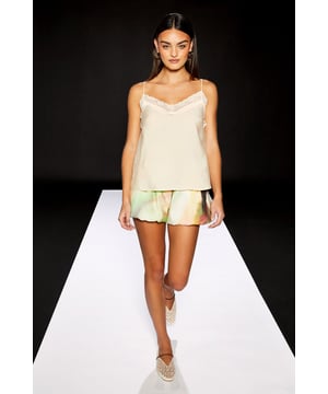 Delicate lace trim detailing along the V neckline adds a feminine touch
        Lightweight viscose fabric ensures comfort for all-day wear
        Adjustable thin straps for a customised fit
        Relaxed silhouette with a floaty finish
        Versatile design perfect for layering or wearing alone
    
    This RUNWAY 1.8.1.8 cami top combines effortless style with everyday comfort. The delicate lace trim creates a subtle statement whilst the relaxed fit offers a flattering silhouette for various body types. Style with printed shorts as shown for a coordinated daytime look, or pair with your favourite denim and trainers for weekend brunches. For a more polished ensemble, layer under a lightweight cardigan or blazer and team with tailored trousers. The versatile nature of this piece makes it ideal for family gatherings, casual coffee dates, or relaxed shopping trips. The simple yet refined design ensures this cami will become a wardrobe staple that transitions seamlessly from day to evening casual occasions.