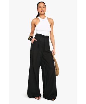 Wide leg design for a relaxed, breezy silhouette
        High-waisted fit accentuates the waistline
        Linen-look fabric offers a lightweight, breathable feel
        Side pockets add functionality to the stylish design
        Versatile trousers suitable for various casual occasions
    
    Embrace effortless chic with these wide leg relaxed fit trousers from Boohoo. The linen-look fabric lends a laid-back, summery vibe to your ensemble, perfect for those balmy days and casual outings. Style these trousers with a cropped wrap top for a coordinated look that's both trendy and comfortable. The high-waisted design flatters your figure, while the relaxed fit through the legs ensures unrestricted movement. Pair with flat sandals for a day of shopping or dress up with wedges for a casual dinner date. These trousers are a versatile addition to your wardrobe, easily transitioning from beachside strolls to family gatherings. The side pockets offer practicality without compromising on style. For a complete look, accessorise with oversized sunglasses and a woven tote bag, channelling that effortless British summer style.