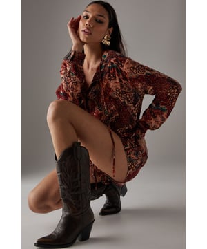 Crafted from lightweight cheesecloth fabric for effortless movement and comfort
        Flattering drop waist silhouette creates a relaxed, feminine shape
        V-neckline with delicate gathering detail adds subtle sophistication
        Long sleeves with gentle volume offer versatile styling options
        All-over print creates visual interest and makes a bold statement
    
    This Warehouse cheesecloth playsuit combines carefree attitude with distinctive style. The drop waist design creates a relaxed silhouette that's both flattering and comfortable for all-day wear. Perfect for weekend adventures, style with western boots for a festival-ready look as shown, or pair with trainers for casual brunches with friends. The rich pattern works beautifully with gold-toned jewellery to enhance the bohemian aesthetic. For cooler days, layer with an oversized denim jacket and add a wide-brimmed hat to complete the look. This versatile piece transitions effortlessly from daytime gatherings to sunset drinks, making it an essential addition to your casual wardrobe. The lightweight fabric ensures comfort whilst maintaining that confident Warehouse edge that defines your personal style.