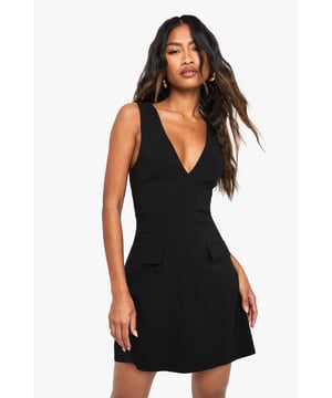 Striking V-neckline creates a flattering silhouette
        Sleeveless design perfect for warmer weather or layering
        Bengaline fabric offers a structured yet comfortable fit
        Functional side pockets add practical detail to this mini dress
        A-line shape skims the body for an effortlessly chic look
    
    This versatile mini dress from Boohoo combines simplicity with statement style. The deep V-neckline creates a striking focal point whilst the clean lines and structured Bengaline fabric ensure a flattering fit that maintains its shape throughout the day. Style with minimal jewellery and strappy sandals as shown for daytime casual events, or transform for evening with statement earrings and ankle boots. The practical side pockets offer a contemporary touch to this wardrobe essential. Perfect for family gatherings when paired with a denim jacket and trainers, or dress down further with a crossbody bag and flat sandals for weekend brunches. The timeless design ensures this piece will remain a go-to option in your wardrobe for seasons to come.