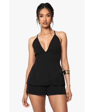 Striking plunge V-neckline for a bold, feminine silhouette
        Elegant cross-back straps that showcase your shoulders
        Lightweight crepe fabric offering comfortable movement
        Flattering peplum-style top that creates a defined waistline
        Versatile short-length design perfect for day-to-night occasions
    
    Make a statement at your next special event with this sophisticated playsuit from Boohoo. The daring plunge neckline creates a captivating focal point, whilst the cross-back design adds an alluring touch that's sure to turn heads. Style with strappy heels and statement jewellery as shown for formal occasions, or dress down with metallic flat sandals for summer soires. The crepe fabric drapes beautifully over your figure, offering both structure and movement as you dance the night away. For cooler evenings, layer with a tailored blazer and clutch a small evening bag to complete your ensemble. This playsuit strikes the perfect balance between chic and practical-ideal for those occasions when you want to stand out from the crowd whilst maintaining effortless elegance.