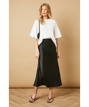 Elegant bias cut design creates a flattering drape that skims the silhouette
        Lustrous satin finish catches the light beautifully as you move
        Mid-calf length offers versatile styling options for various occasions
        Smooth waistband sits comfortably at the natural waist
        Fluid A-line shape provides effortless movement throughout the day
    
    This Oasis bias cut midi skirt brings timeless sophistication to your everyday wardrobe. The diagonal cutting technique creates a gorgeous drape that flows with your body, whilst the satin finish adds a subtle touch of luxury to casual ensembles. Style as seen with a relaxed oversized tee and minimal flip-flop sandals for an effortlessly chic daytime look. For family gatherings or brunches with friends, pair with a fitted knit top and ballet flats. The versatile midi length works beautifully with trainers for a contemporary twist, or dress it up with block-heeled mules for dinner dates. This skirt transitions seamlessly from weekend shopping trips to casual office settings when paired with a crisp button-down and loafers. A true wardrobe essential that combines feminine charm with practical wearability.