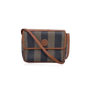 VINTAGE, RRP AS NEW
Step into a world of timeless Italian design with this vintage Fendi Pequin Striped Canvas Small Crossbody Bag, a chic accessory that perfectly balances style and functionality. The iconic striped pequin canvas, with its bold alternating tones, is paired beautifully with rich brown leather trim and a sturdy leather shoulder strap, creating a look that's both sophisticated and effortlessly cool.  This small crossbody bag features a flap with a magnetic button closure, ensuring your belongings are secure yet easily accessible. Inside, the black leather lining offers a smooth, luxurious feel, while a side zip pocket adds an extra touch of practicality for organizing your essentials. The interior is also marked with the "Fendi s.a.s. Roma - Made in Italy" , a signature of the craftsmanship that has made Fendi a global luxury icon.  Whether you're adding a statement piece to your collection or simply looking for a stylish, functional bag for everyday wear, this Fendi Vintage Pequin Striped Canvas Crossbody Bag is a must-have. Its combination of classic design and modern utility makes it the perfect addition to any wardrobe. Condition Rating: B - VERY GOOD CONDITIONCondition Details: Gently used. Some normal wear of use on leather trim. Please check the photos carefully and ask if you need to know more details or if you have any doubts.Measurements (cm):Depth: 6.4Height: 14.0Length: 17.8Other Details: Dustbag? NoKeys? NoBox? No Measurments:  width: 64 mm length: 178 mm height: 140 mm