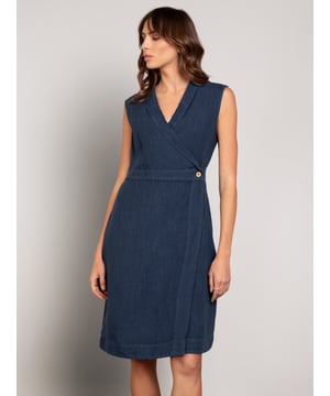 This wrap dress features a shawl collar neckline with adjustable self-ties at the back for a custom fit. Knee-length and sleeveless with practical side-seam pockets, it combines easy style with versatility.