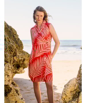 This wrap dress features a shawl collar neckline with adjustable self-ties at the back for a custom fit. Knee-length and sleeveless with practical side-seam pockets, it combines easy style with versatility.