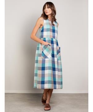 This sleeveless midi dress is made from a mid-weight, woven fabric. The large scale gingham print is bright and summery. The skirt is gathered at the waist seam to provide a full, drapey appearance, and has large patch pockets that are cut on the bias, adding nice detail. The crew neckline features a keyhole detail with two coconut buttons and loop fastenings.