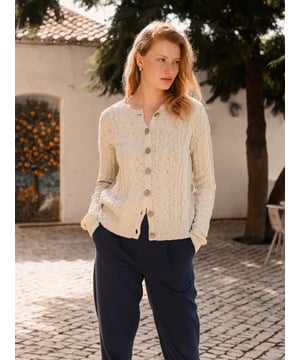 This cardigan has a classic cable-knit pattern with a relaxed, drop-shoulder shape, finished with natural coconut buttons. The cotton-linen blend lends an airy feel, while the crew neckline and boxy fit create an easy, everyday layer.