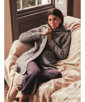 The Donegal longline coatigan is the perfect mix between a coat and a cardigan, thanks to the chunkier weight Donegal yarn that it is knitted from. With its statement shawl collar, edge to edge styling and longer length you can wear it both outside and in, depending on what the Great British weather throws your way. Details include patch pockets and a ribbed collar and cuffs.
