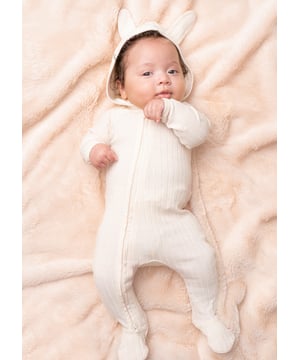 Introduce your little ones to the whimsical world of rabbits with this charming neutral rib baby grow. featuring a rabbit ear design and even a tail for extra cuteness! Crafted with care and comfort in mind. it's the perfect combination of style and comfo.