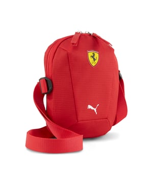 PRODUCT STORY: Carry your essentials in style with our modern, sleek design. Featuring a premium TPU Ferrari shield logo, adjustable shoulder strap, and multiple compartments, this lightweight portable bag is perfect for everyday use. Feel the energy with PUMA. FEATURES & BENEFITS: Made with at least 50% recycled materials. DETAILS: Modern portable sleek design; Two-way zipped main compartment; Internal slip pocket; Airmesh back; PUMA branding details.