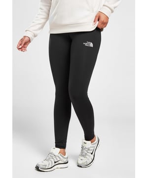 Women's Never Stop Exploring Tights from The North Face in a Black colourway. - - .  These tight-fit leggings are made from smooth and stretchy poly fabric that's easy to move in. - -.  They feature full-length legs and a stretchy, elasticated waistband for a custom feel. - - .  With the signature Never Stop Exploring slogan, these tights are finished up with reflective details to keep you seen and The North Face branding. - - .  Machine washable. - - .  Our model is 5'6" and wears a size small.