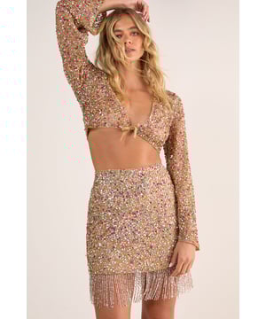 Dazzling sequin and pearl embellished mini skirt with eye-catching tassel fringe hem
        Tie side detail for an adjustable fit and added style dimension
        Lightweight knitted construction offering comfort whilst maintaining shape
        Pairs perfectly with the matching long-sleeve crop top for a coordinated set
        Shimmering metallic net fabric creates a stunning light-catching effect ideal for evening events
    
    Make a statement at your next beachside soire with this show-stopping mini skirt from Nasty Gal. The combination of sequins, pearls and metallic net fabric creates a mesmerising shimmer that catches the light with every movement, whilst the playful tassel fringe adds dynamic texture and movement. Style with the matching crop top as shown for maximum impact, or pair with a simple bandeau and strappy sandals for a more relaxed poolside look. This versatile piece transitions effortlessly from daytime beach club to evening cocktails - simply add oversized sunglasses and a clutch bag for the ultimate holiday ensemble. The tie side detail allows for a customised fit, ensuring comfort throughout your sun-soaked adventures. Perfect for destination parties, tropical getaways or simply making a splash at any summer gathering.