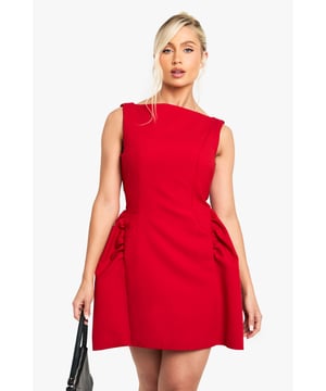 Striking Volumen skater dress with a flattering structured silhouette
        Sleeveless design with a chic slash neckline for a contemporary look
        Distinctive side pleats create dramatic volume and movement
        Short length perfect for showcasing your legs
        Clean, minimalist design makes it ideal for accessorising to suit your style
    
    Make a bold statement in this eye-catching Volumen skater dress from Boohoo. The architectural silhouette features dramatic side pleats that create stunning volume and movement as you walk, dance, or simply turn heads at your next night out. Style with strappy heels as shown for a classic going-out ensemble, or customise with statement jewellery to reflect your personal flair. This versatile piece transitions effortlessly from drinks with the girls to club nights in the city. The sleeveless cut and slash neckline offer a modern, fresh aesthetic while maintaining a sophisticated edge. Complete your look with a compact handbag and sleek updo for a night of urban adventures where you'll radiate confidence and style.