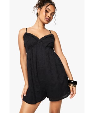 Crafted from delicate broderie anglaise fabric with intricate eyelet detailing
        Feminine V-neckline with scalloped trim for a romantic touch
        Adjustable spaghetti straps for a customised fit
        Relaxed silhouette with a flattering empire waistline
        Lightweight design perfect for warm-weather occasions
    
    This charming broderie anglaise playsuit from Boohoo combines comfort with effortless style. The delicate eyelet pattern and scalloped trim create a feminine aesthetic that works beautifully for daytime events. Style with flat sandals and stacked bangles as shown for casual gatherings, or dress up with espadrille wedges and a woven clutch for garden parties. The relaxed fit makes it ideal for family barbecues or weekend brunches, while the all-in-one design offers practicality without compromising on style. For cooler evenings, layer with a lightweight denim jacket and switch to ankle boots for versatility that transitions through the seasons. This playsuit embodies carefree summer dressing with its easy-to-wear appeal and timeless broderie fabric.