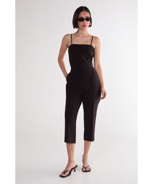 Sleek capri-length playsuit with tailored fit for a flattering silhouette
        Elegant square neckline with delicate adjustable spaghetti straps
        Practical side pockets for convenient storage of small essentials
        Cropped leg design offers a modern, sophisticated twist on classic playsuit styling
        Structured woven fabric provides comfortable stretch while maintaining shape
    
    This versatile Nasty Gal playsuit combines timeless tailoring with contemporary design for effortless style. The structured capri-length creates a refined silhouette that works beautifully for casual daytime events. Style with strappy kitten heels and statement earrings as seen on our model for family gatherings, or dress down with trendy trainers and an oversized tote for weekend brunches. The clean lines and minimalist design make this piece particularly adaptable for transitional weather-simply layer with a lightweight cardigan or cropped jacket when temperatures drop. The tailored fit flatters the waistline while the practical pockets add functionality to this chic wardrobe staple. Perfect for those seeking a balance of comfort and style for various casual occasions.