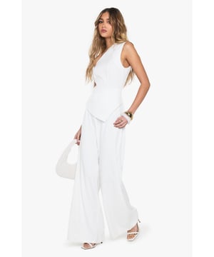 One-shoulder asymmetric neckline for a bold statement
        Wide-leg silhouette offering comfort and style
        Sleek crepe fabric for a polished look
        Single sleeve design adding a unique twist
        Floor-length cut for an elongating effect
    
    Make a striking entrance in this one-armed wide-leg jumpsuit from Boohoo. The asymmetric neckline and single sleeve design create a captivating silhouette that's sure to turn heads. Perfect for casual events or family gatherings, this versatile piece can be dressed up or down with ease. Pair with flat sandals and minimal jewellery for a relaxed daytime look, or add statement earrings and a clutch bag for evening drinks. The wide-leg cut offers both comfort and style, while the crepe fabric ensures a smooth, flattering fit. Ideal for the fashion-forward woman who wants to stand out without compromising on comfort, this jumpsuit is a must-have addition to your wardrobe. Its clean lines and modern design make it a go-to choice for those impromptu plans or when you want to feel effortlessly chic.