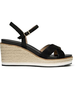 The Cole Haan Silvee brings sophisticated elevation to warm-weather dressing with its luxurious nubuck upper and distinctive rope-edged sole. This black espadrille sandal features a secure buckle closure and generous 9cm heel that adds statuesque height while maintaining comfort through its cushioned insole. The rubber and rope sole construction delivers both style and durability, making it perfect for everything from weekend brunches to evening gatherings.
