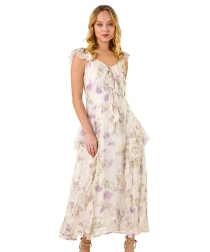 Dusk Floral Print Ruffle Maxi Dress from Roman. Make a stunning entrance this Spring Summer season in this floral print maxi dress. Embrace your feminine side with the v-neckline and flutter sleeves adorned with delicate ruffle detailing. The blooming floral print adds a touch of romance, while the comfortable woven chiffon fabric ensures a flattering flowy silhouette at maxi length. Complete the look with a bolero and heels for any special occasion!