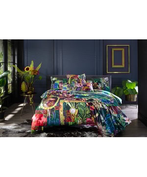 Transform your bedroom into a haven of luxury with the 100% Cotton Signature Teal Duvet Cover Set. This set, featuring a digitally printed heron motif amidst vibrant floral patterns, blends nature-inspired charm with elegance. The premium cotton, with a 200 thread count, ensures breathability and softness, providing ultimate comfort for a restful sleep. Exuding sophistication and durability, the duvet cover is highlighted by a piped finish, making it a timeless addition to your decor. Showcasing a palette of pinks, purples, and soft blues, it complements both classic and modern bedroom settings. Included in the bedding set is a free decorative cushion (35cm x 35cm) with a pom-pom trim that matches your chosen set, doubling as the outer packaging for the cushion cover.