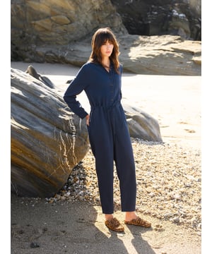 With a collared neckline and relaxed fit, this jumpsuit features a drawstring waistband for an adjustable silhouette. Crafted from  cotton, it provides both comfort and versatility, making it a go-to choice for effortless day-to-night dressing.