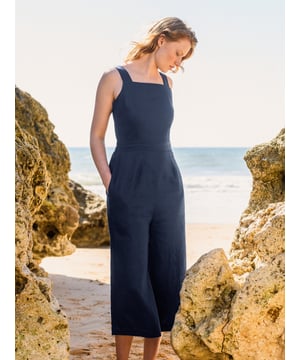 This jumpsuit showcases a square neckline and a fitted waist with an elasticated back for comfort. Featuring a side zip and wide cropped trouser legs, it combines ease of wear with a contemporary silhouette.