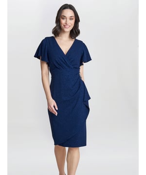 Feel glamorous in this gorgeous dress by Gina Bacconi. Perfect for a party or special occasion, the dress is fashioned from a sprakle jersey. This dress features a wrap-over bodice and embellished trim at the waist which flatters the waistline gorgeously. This dress has fluted sleeves and a zip at the centre back.