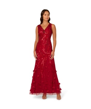3D flower appliques trail down the skirt of this gorgeous sleeveless maxi dress for a moment of whimsical romance. The floral embellishments finish a bead and sequin design that sparkles and shimmers from the keyhole V-neckline down past the hips. The final effect of the intricate beading is to emphasize the stunning mermaid silhouette of this gown. A back zipper closure ensures the perfect fit. Wear this sumptuous gown to make a grand entrance at your next event.