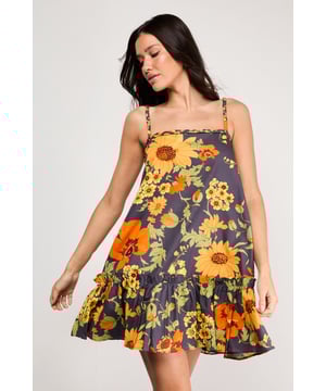 Distinctive plaited straps add a unique textural element to this breezy sundress
        Relaxed A-line silhouette with a feminine flounced hem for added movement
        Square neckline creates a flattering frame for the dcolletage
        Lightweight cotton poplin fabric ensures comfort during warmer days
        Bold floral print makes a confident statement while maintaining versatility
    
    This effortlessly chic sundress captures the essence of carefree summer style with its relaxed silhouette and eye-catching floral pattern. The plaited straps offer a distinctive design element that sets this piece apart, while the flounced hem adds a playful touch to your movement. Style with flat sandals as shown for daytime outings or family gatherings, or dress up with espadrille wedges and statement earrings for garden parties. The cotton poplin fabric ensures breathability during warmer weather, making this an ideal choice for holidays abroad or weekend brunches. Layer with a cropped denim jacket when temperatures cool, or wear over a fitted tee for a contemporary layered look. This versatile sundress transitions seamlessly from casual daytime events to relaxed evening occasions with just a few accessory changes.