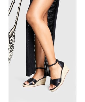 Wide fit espadrille wedges with crossover strap design for enhanced comfort
        Adjustable ankle strap with buckle fastening for a secure fit
        Classic rope-wrapped wedge heel measuring between 2.5-4.5cm for subtle height
        Open toe silhouette perfect for showcasing summer pedicures
        Versatile design that transitions effortlessly from beach to evening dining
    
    These Boohoo wide fit espadrille wedges combine timeless summer style with practical comfort. The crossover strap design creates a flattering shape across the foot, whilst the adjustable ankle strap ensures these beauties stay securely in place all day long. Style them with a flowing maxi dress and oversized straw bag for beachside strolls, or pair with cropped linen trousers and a fitted blouse for seaside dining. The modest wedge height offers just enough elevation without sacrificing comfort, making these the perfect holiday companion. Their versatile aesthetic works brilliantly for daytime exploration of coastal towns or evening cocktails as the sun sets. The espadrille base adds that quintessential summer touch that will have you reaching for these wedges season after season.