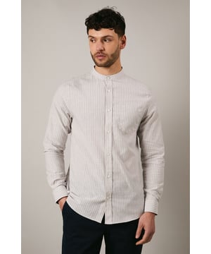 Distinctive grandad collar design for a contemporary twist on classic shirting
        Subtle stripe pattern woven throughout the fabric for understated visual interest
        Long sleeves with buttoned cuffs offering versatile styling options
        Chest pocket detail adding functional practicality to the design
        Relaxed fit with a curved hem perfect for both tucked and untucked styling
    
    This Maine grandad collar shirt combines timeless appeal with modern sensibility. The clean-lined design makes it an effortless addition to your casual wardrobe, whilst the distinctive collar creates a relaxed yet refined aesthetic. Style with dark trousers and loafers as shown for family gatherings or weekend brunches. For a more laid-back approach, pair with chinos and trainers for everyday wear. The versatile nature of this shirt makes it ideal for transitional weather - layer under a lightweight jacket when temperatures drop or wear alone with rolled sleeves during warmer days. The button-through front and woven fabric ensure comfort and ease of movement, making this shirt a practical choice for various casual occasions without compromising on style.