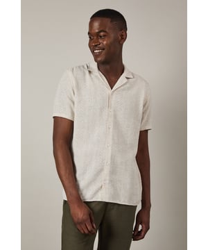Textured woven fabric adds subtle dimension and visual interest to this casual shirt
        Classic revere collar design creates a relaxed yet refined neckline
        Short sleeves with neat hems perfect for warmer weather
        Button-through front with matching buttons for a clean finish
        Regular fit provides comfortable wear without being overly loose
    
    This Burton textured short sleeve shirt combines casual comfort with understated style. The natural textured fabric offers breathability whilst the revere collar adds a touch of laid-back sophistication that works brilliantly for various casual settings. Style it as shown with chinos or trousers in earthy tones for a balanced look, or pair with your favourite denim for weekend outings. The versatile design makes it ideal for summer barbecues, casual Friday office wear, or meeting mates at the local for a pint. Layer under a lightweight jacket when the temperature drops or wear unbuttoned over a plain t-shirt for a more relaxed approach. This shirt transitions effortlessly from daytime casual to evening gatherings, making it a practical addition to your warm-weather wardrobe that will serve you well for seasons to come.
