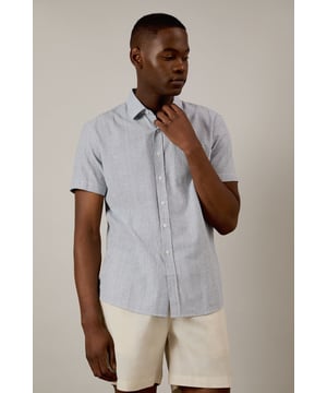 Classic fine stripe pattern for a refined casual look
        Short sleeves with neat hems for warm-weather comfort
        Traditional collar with structured shape
        Convenient chest pocket for added functionality
        Regular fit design offering ease of movement throughout the day
    
    This Burton short sleeve shirt combines timeless style with everyday practicality. The fine stripe pattern creates visual interest while maintaining versatility for various occasions. Pair with chino shorts and loafers as shown for a smart casual weekend look perfect for beer garden gatherings or family barbecues. For cooler evenings, layer under a lightweight jumper or team with dark denim jeans and trainers for pub outings with mates. The woven fabric offers breathability and comfort during sporting events or casual match viewings. This shirt transitions effortlessly from daytime casual to evening socialising, making it an essential addition to any practical British wardrobe. A reliable choice for the man who values classic style with contemporary appeal.