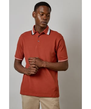 Distinctive jacquard collar with contrasting stripe detail
        Classic button placket with durable buttons for longevity
        Soft cotton fabric for all-day comfort
        Ribbed sleeve cuffs with matching trim for a refined finish
        Regular fit silhouette offering ease of movement
    
    This Burton polo shirt combines timeless style with contemporary detailing, making it a versatile addition to your casual wardrobe. The standout jacquard collar adds character to an otherwise classic design, while the cotton construction ensures breathability and comfort throughout the day. Style it as shown with neutral chinos and white trainers for an effortlessly smart-casual look perfect for weekend pub gatherings or family barbecues. For cooler evenings, layer under a lightweight bomber jacket or casual blazer. The versatile design transitions seamlessly from daytime outings to relaxed evening socials, offering the reliability and understated style that Burton is known for. Machine washable at 30 degrees, this polo maintains its shape and colour with proper care.