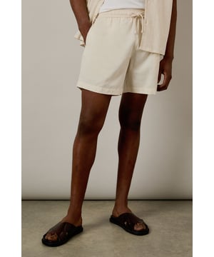 Crafted from a linen blend fabric for breathable comfort in warmer weather
        Relaxed fit with mid-thigh length for easy movement and versatile styling
        Practical side pockets for essentials
        Drawstring waistband for adjustable comfort
        Versatile design that pairs effortlessly with both casual and smart-casual attire
    
    These Burton linen blend shorts offer the perfect balance of comfort and style for the modern man. The breathable fabric makes them ideal for warm weather, whether you're enjoying a weekend barbecue or heading to the beer garden with mates. Style them as shown with a matching shirt for a coordinated summer look, or pair with a simple t-shirt for more casual occasions. The relaxed silhouette and practical pockets make these shorts a practical choice for family gatherings, sporting events, or casual Friday at the office. Machine washable at 30 degrees, they're designed with everyday practicality in mind. These shorts will quickly become your go-to for summer weekends, holiday packing, and casual outings where comfort meets laid-back style.