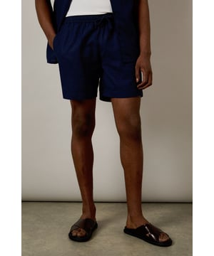 Linen blend fabric offers breathable comfort for warm-weather wear
        Relaxed fit with elasticated waistband for all-day ease
        Side pockets provide practical storage for essentials
        Mid-thigh length creates a flattering silhouette
        Versatile design that pairs effortlessly with both casual and smart-casual attire
    
    These Burton shorts combine comfort and style for the modern man who values both practicality and appearance. The linen blend construction ensures breathability during warmer months whilst maintaining a structured look that works across multiple settings. Style them as shown with a crisp white t-shirt and matching short-sleeved shirt for a coordinated summer ensemble perfect for weekend barbecues or casual pub gatherings with mates. For a more relaxed approach, pair with your favourite graphic tee and trainers for an effortless daytime look. The neutral tone makes these shorts incredibly versatile, allowing them to complement your existing wardrobe with ease. Ideal for family gatherings, sporting events or casual outings, these shorts will quickly become your go-to choice for comfortable yet presentable summer dressing.