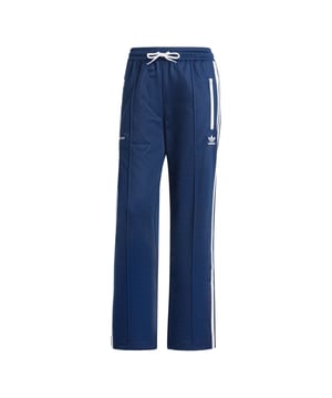 Womens adidas Originals x Sporty & Rich Tracksuit Bottoms in night indigoGood health starts here. The collaboration between adidas Originals and LA-based lifestyle brand Sporty & Rich celebrates originality  diversity and inclusivity while also aiming to empower an open dialogue on self-care  self-love and mental health. These track pants are made from a soft cotton blend with open hems and a drawcord-elastic waist. Hidden zips on the legs let you play with the silhouette. Logos beneath the front zip pockets sign off the look.- Track pants with hidden zips  made in collaboration with Sporty & Rich.- Drawcord on elastic waist- 52% cotton  48% polyester (recycled)- Front zip pockets- Open hems- Machine wash cold delicate cycle- Ref: JD3768