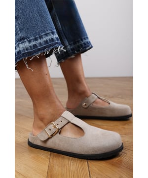 Refresh your casual look with these Sasha Clog Inspired Flatform Slider Sandals, perfect for laid-back days with a modern edge. Crafted from soft suede-look material, they feature a chic clogs design and gold buckle detail. The molded footbed ensures all-day comfort, while the flatform sole adds subtle height. Ideal for everyday comfort, work-from-home wear, or weekend strolls. Key Features: • Material: Faux suede upper with cushioned insole and textured sole • Design: Closed-toe clog with gold-tone buckle hardware • Closure: Adjustable buckle strap at the side