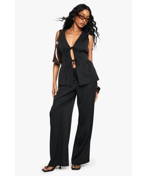 Straight leg trousers crafted from smooth woven crepe fabric
        Flattering high-rise waistband with secure zip fastening
        Clean, streamlined silhouette for effortless day-to-night versatility
        Relaxed straight-leg cut offering both comfort and contemporary style
        Designed to pair perfectly with the matching tie-front waistcoat for a coordinated look
    
    These straight leg trousers from Boohoo deliver the perfect balance of comfort and contemporary style. The clean lines and fluid drape of the woven crepe fabric create a silhouette that works brilliantly for various occasions. Style them as seen with the matching tie-front waistcoat and flat sandals for a relaxed daytime ensemble, or dress them up with a fitted blouse and heels for evening drinks. The versatile design makes these trousers ideal for family gatherings or casual brunches with friends. Their timeless appeal means they'll become a wardrobe staple you'll reach for time and again, easily transitioning between seasons with simple styling tweaks. The straight leg cut flatters all body types while providing unrestricted movement throughout your day.
