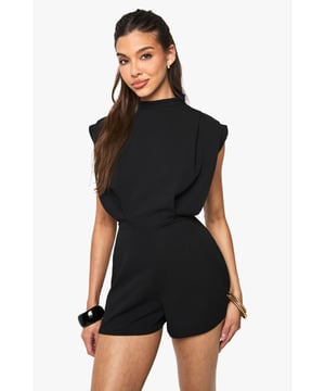 Sophisticated high neck design with elegant pleat detailing for a refined silhouette
        Structured cap sleeves with subtle padding create a contemporary, fashion-forward look
        Tailored fit with cinched waist to showcase your figure beautifully
        Soft Liverpool Crepe fabric offers comfortable stretch whilst maintaining shape
        Versatile short length perfect for showcasing your legs and favourite heels
    
    Make a striking impression in this tailored playsuit that combines sophistication with contemporary edge. The high neck and structured shoulders create a powerful silhouette, whilst the pleated detailing adds texture and visual interest. Perfect for evening drinks or club nights, this playsuit offers the ideal balance of comfort and style. Style with strappy heels and statement gold jewellery as shown for maximum impact, or dress down with chunky trainers and an oversized clutch for urban cool. The flattering cinched waist design creates an hourglass shape that works brilliantly for various body types. For cooler evenings, layer with a cropped jacket or blazer without compromising on style. This Boohoo piece transitions effortlessly from cocktail bars to dance floors, ensuring you stand out for all the right reasons.