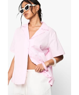 Boxy fit short sleeve shirt with resort-inspired print for a laid-back holiday vibe
        Classic collar and button-through front offering versatile styling options
        Relaxed shoulders and roomy sleeves creating a contemporary silhouette
        Linen-look fabric providing a textured finish perfect for warmer weather
        Straight hem design that works brilliantly worn loose or tucked in
    
    Channel effortless resort style with this oversized short sleeve shirt from Boohoo. The boxy silhouette creates a relaxed yet fashion-forward look that's ideal for casual occasions. Style it open over a crop top with white shorts and sandals for daytime outings, or button it up and pair with linen trousers for family gatherings. The versatile design works wonderfully half-tucked into high-waisted jeans with trainers for a casual coffee date. For cooler evenings, layer under a lightweight jacket and accessorise with statement sunglasses and a mini handbag as seen on our model. This shirt transitions seamlessly from city breaks to beachside holidays, making it a must-have addition to your warm-weather wardrobe that delivers on both comfort and style.