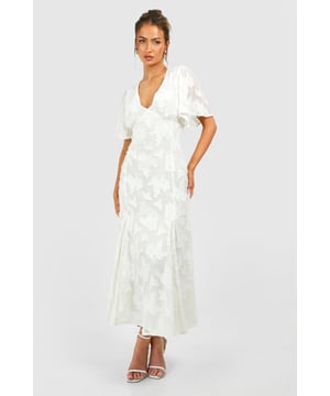 Elegant midi dress with floral jacquard pattern
        Flattering V-neckline and wide flutter sleeves
        Fitted waist for a feminine silhouette
        Flowy skirt with subtle flare towards the hem
        Back zip closure for easy dressing
    
    Make a statement at your next special occasion with this enchanting midi dress from Boohoo. The eye-catching floral jacquard fabric adds texture and visual interest, while the V-neckline and wide flutter sleeves create a romantic, feminine look. The fitted waist cinches in your figure before flowing into a graceful skirt that falls just below the knee. Perfect for weddings, garden parties, or sophisticated evening events, this versatile piece can be styled to suit various settings. Pair with strappy heels and delicate jewellery for a classic ensemble, or add a bold clutch and statement earrings to amp up the glamour. The dress's timeless design ensures it will remain a go-to choice in your wardrobe for seasons to come, offering both style and comfort for those moments when you want to feel effortlessly chic.