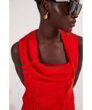 This Karen Millen sleeveless jacket redefines workwear with its architectural draping and contemporary asymmetric design. The structured yet fluid silhouette offers a refined alternative to traditional tailoring, making it an essential piece for the modern professional wardrobe. Style with wide-leg trousers for a balanced silhouette that projects confidence and sophistication. For office meetings, layer over a crisp white shirt with tailored trousers and pointed court shoes. Transition to evening events by pairing with a slim-fitting pencil skirt and statement jewellery.  Sleeveless tailored jacket with asymmetric neckline and drape detail Structured silhouette Button fastening Practical front pockets