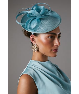 Exquisite structured fascinator crafted from premium abaca fibers
Striking side-facing design with sculptural curves and folds
Lightweight yet sturdy construction for all-day wear
Vibrant hue to complement formal ensembles
Delicate trims add an elegant finishing touch

Radiate sophistication and refinement at your next special occasion with this striking fascinator from Coast. The structured silhouette and side-facing design exude a modern, architectural aesthetic that will elevate your formal look. Whether attending a wedding, the races, or a graduation ceremony, this fascinator is the perfect accessory to complete your ensemble with a touch of luxury and style. Pair it with a tailored dress or suit for a polished, fashion-forward appearance that commands attention.