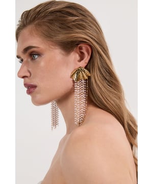 These Karen Millen statement earrings command attention with their distinctive shell design and luxurious pearl-effect tassels. The architectural gold-tone structure provides a sophisticated foundation for the delicate strands that sway gracefully with your movements. Perfect for elevating formal attire, pair these showstoppers with an elegant updo and a sleek evening gown for weddings or black-tie events. The earrings also work with simpler outfits, pair with a crisp white shirt and tailored trousers to add instant glamour to business attire.   Shell-shaped stud design with pearl-effect tassels Dramatic statement length Textured metallic finish Secure post fastening Versatile design that transitions effortlessly from day to evening occasions