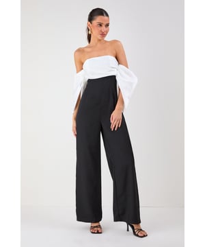 Striking bardot neckline with dramatic volume sleeves for a bold silhouette
        Elegant bandeau bodice with structured design for a flattering fit
        Flowing wide-leg trousers create a sophisticated and elongating effect
        Sleek back design showcases shoulders for a touch of allure
        Versatile jumpsuit perfect for formal occasions and evening events
    
    Make a statement entrance in this show-stopping bardot jumpsuit from Misspap. The dramatic volume sleeves create an architectural silhouette that commands attention, whilst the clean lines of the wide-leg cut offer effortless movement as you glide across the room. Style with strappy heels and statement earrings as seen on our model for maximum impact at summer weddings or cocktail parties. For cooler evenings, drape a tailored blazer over your shoulders without compromising the jumpsuit's striking sleeve detail. The bandeau neckline beautifully frames your dcolletage, making this piece ideal for showcasing a special necklace or simply letting the garment's elegant design speak for itself. A true occasion piece that balances contemporary drama with timeless sophistication.