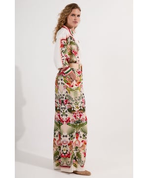 These Karen Millen petite trousers showcase a captivating mirrored floral print that demands attention. The wide leg design creates a flowing silhouette that moves with every step, whilst the natural raffia belt adds an artisanal touch to the overall aesthetic. Style as seen with a crisp white shirt for a balanced look that works for daytime occasions. The viscose linen blend ensures these trousers remain comfortable throughout warmer days, making them ideal for garden parties or casual brunches. Pair with flat sandals and a woven tote for family gatherings, or dress up with espadrille wedges for alfresco dining. The versatile nature of these trousers allows for countless styling options throughout the season.  Wide leg silhouette with striking mirrored floral print throughout Distinctive raffia belt with statement buckle Crafted from a breathable viscose linen blend Petite fit designed specifically for smaller frames