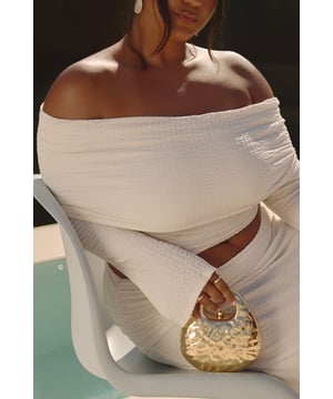 Eye-catching metallic finish with a unique hammered texture
        Compact size perfect for essentials on a night out
        Distinctive teardrop shape with rounded edges
        Sturdy top handle for easy carrying
        Detachable chain strap for versatile wear options
    
    Make a statement on your next night out with this striking metallic handbag. The hammered texture catches the light beautifully, ensuring you'll stand out in any crowd. Its compact size is ideal for carrying your essentials without weighing you down as you dance the night away. The unique teardrop shape adds a touch of avant-garde style to your ensemble, while the sturdy top handle allows for effortless carrying. For hands-free convenience, simply attach the included chain strap. Pair this showstopper with a sleek bodycon dress and strappy heels for a head-turning club look, or dress it down with high-waisted jeans and a silky camisole for drinks at a trendy bar. This versatile piece is sure to become your go-to accessory for all your nightlife adventures.