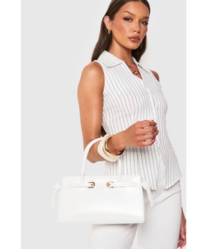 Structured design with elegant gold-tone buckle detailing
        Spacious interior with secure magnetic closure
        Versatile top handles for comfortable carrying
        Sleek rectangular silhouette perfect for day-to-night transition
        Durable construction with clean lines and minimal hardware
    
    This structured handbag combines sophistication with practicality for your nights out. The clean, architectural shape creates a polished look whilst the gold-tone buckle adds a touch of glamour without overwhelming your outfit. Style with a crisp button-up and tailored trousers for drinks after work, or pair with your favourite bodycon dress when heading to the club. The versatile design works brilliantly with both monochrome ensembles and bold prints, making it your go-to accessory for urban nightlife. With enough room for your essentials yet compact enough to carry comfortably all night, this Boohoo bag strikes the perfect balance between fashion and function. The timeless design ensures it will remain a staple in your collection for countless nights out.