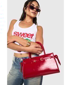 Structured design with elegant buckle detail and gold-tone hardware
        Sleek top handle for sophisticated hand-carry option
        High-shine finish for a statement look
        Spacious interior with zip pocket for secure storage
        Adjustable side buckles for customisable shape
    
    This structured handbag combines practicality with urban chic, perfect for elevating your night-out ensemble. The distinctive buckle detail and glossy finish create a bold statement piece that commands attention, whilst the compact yet roomy interior offers ample space for your evening essentials. Style with contrasting casual pieces like distressed denim and a graphic top for an effortlessly cool look, or pair with a sleek bodycon dress and strappy heels for a more polished club appearance. The versatile size makes it ideal for drinks with friends or dancing the night away, whilst the secure fastening ensures your belongings stay safe throughout your adventures. A true Boohoo staple that transitions seamlessly from early evening cocktails to late-night revelry.